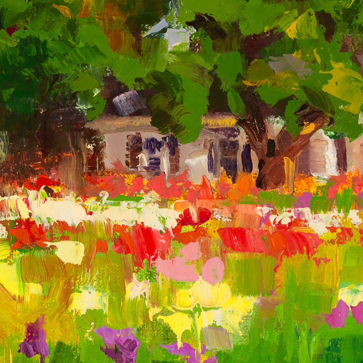 Close up detail of a Dahlia Evening canvas print featuring a white farmhouse and trees behind a field of colorful dahlias in the afternoon light.