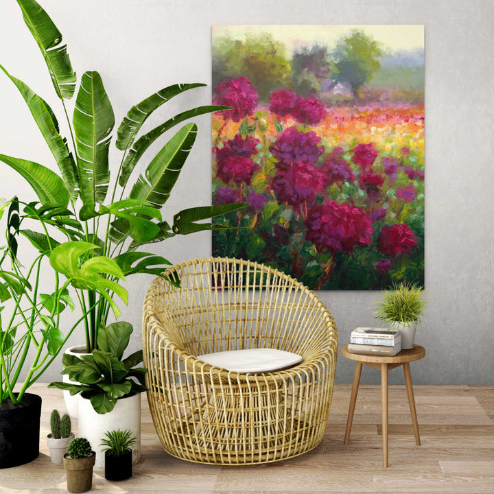 Boogie Nites, an impressionist oil painting landscape of Swan Island Dahlias hangs on a wall behind wicker chair and plants.