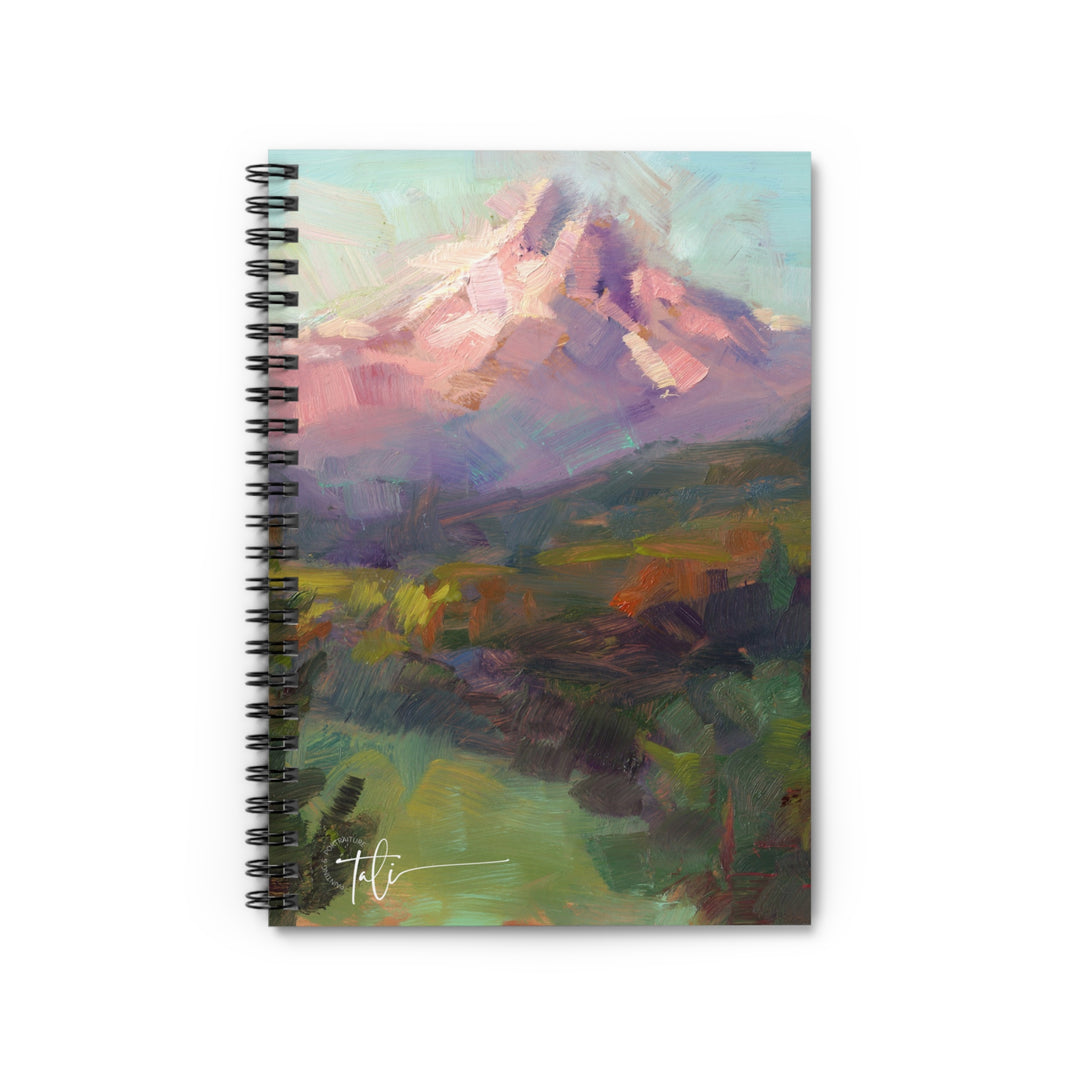 Notebook with a mountain landscape cover on a white background