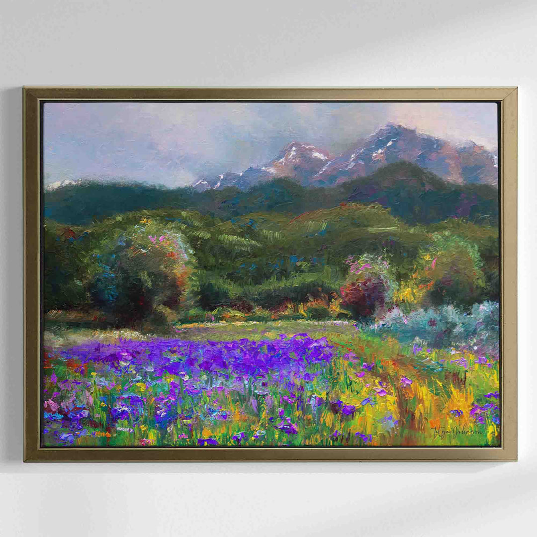 Alaska art canvas print in gold floater frame of original flower landscape painting painted with a palette knife in modern impressionism style depicting wild iris flower landscape with mountains and trees in the background.