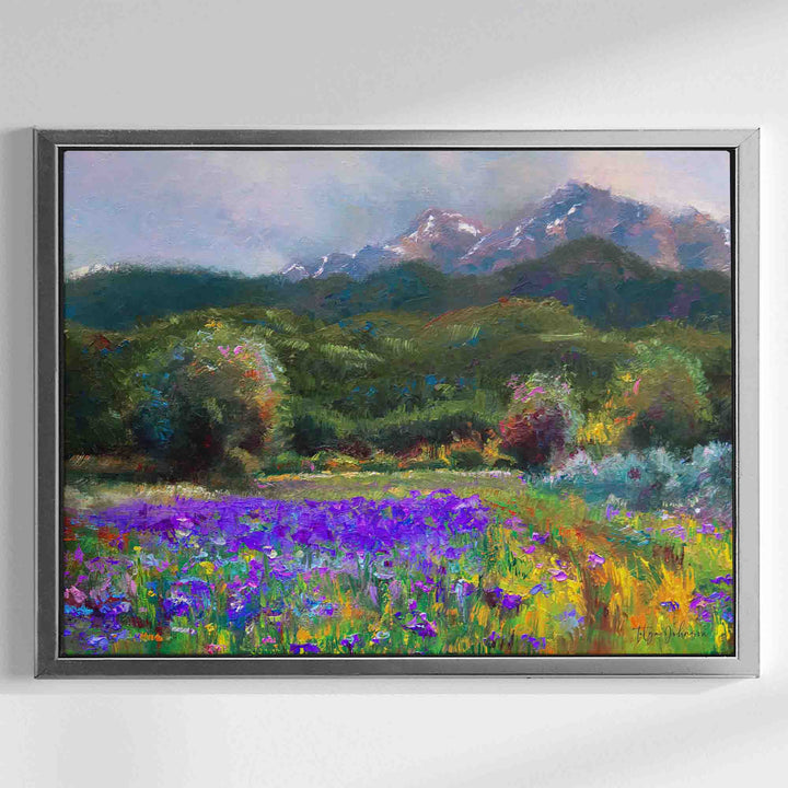 Alaska art canvas print in silver floater frame of original flower landscape painting painted with a palette knife in modern impressionism style depicting wild iris flower landscape with mountains and trees in the background.