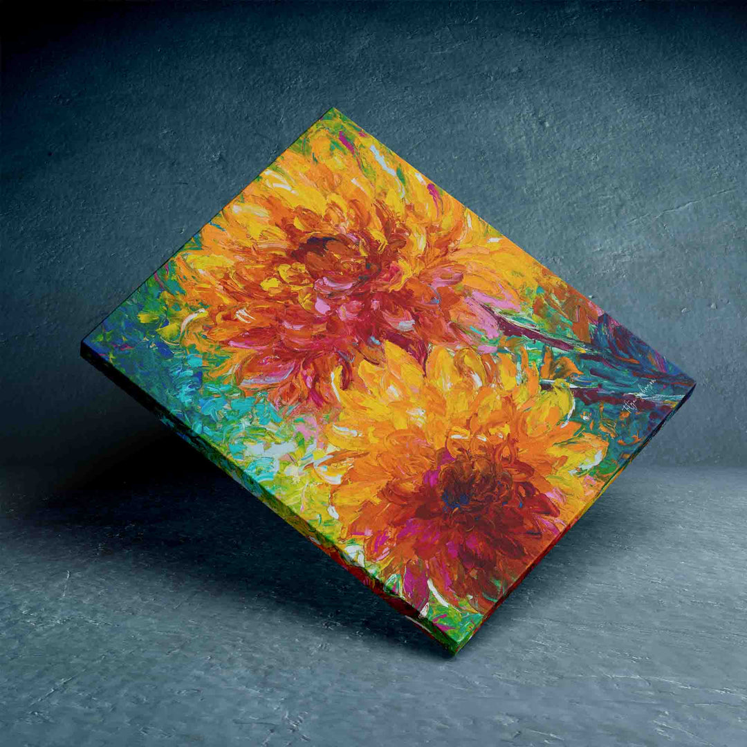 Talya Johnson wall art canvas print giclee balancing on corner featuring  intertwining orange dahlia painting with yellow and red and magenta centers painted on an abstracted blue green background.