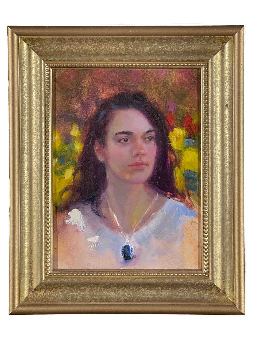 Realistic oil portrait painting of young woman with dark wearing white dress and blue pendant with tulips in garden; the small artwork was painted by Oregon artist Talya Johnson, and is pictured in a gold frame.