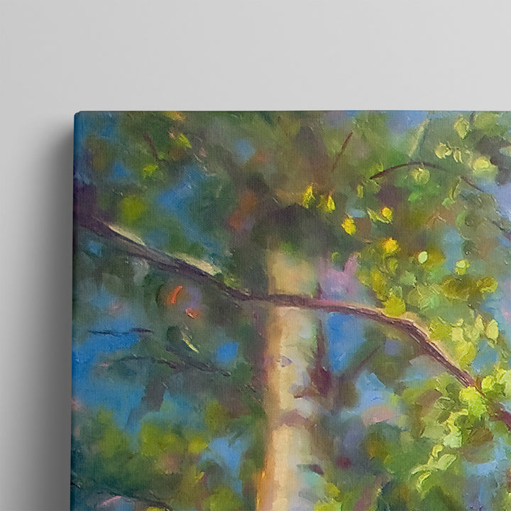 Close up detail of canvas print giclee of a tree with green leaves and a blue sky background