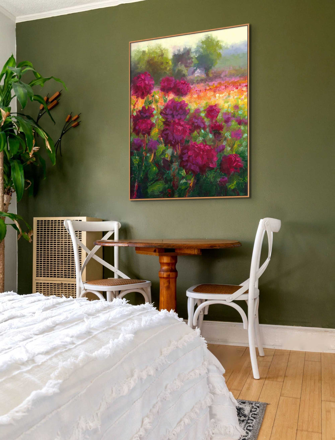 Boogie Nites, a large canvas wall art print of an impressionist oil painting landscape of Swan Island Dahlias hangs on a green wall in a cozy maximalist bedroom.