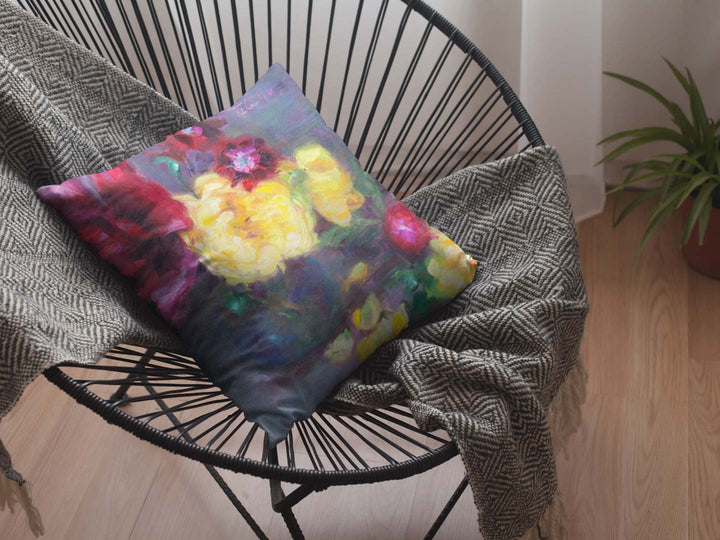 throw pillow on a black acapulco chair Lemon and Magenta flowers and radish Throw Pillow with floral impressionist artwork by talya johnson