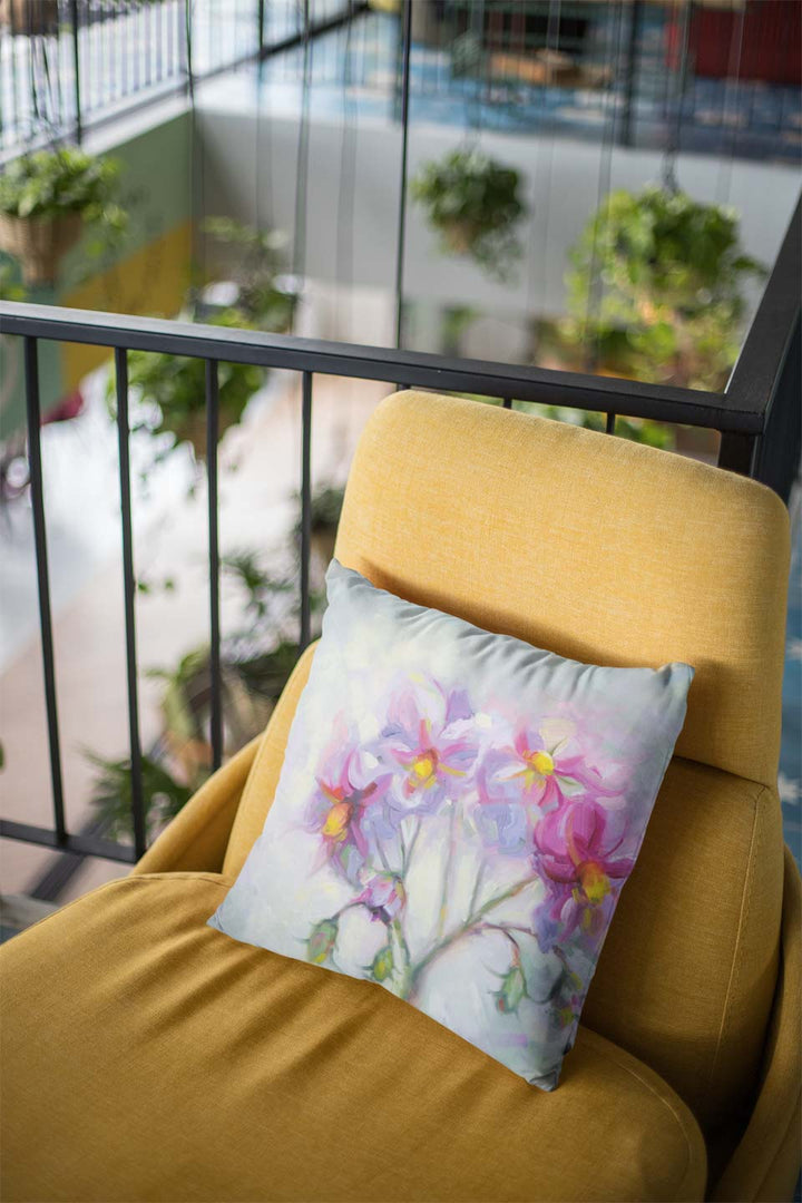 throw pillow mockup lying over a modern yellow couch featuring impressionist floral painting of pink flowers by talya johnson