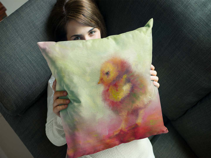 throw pillow with impressionist artwork of a baby chicken by talya johnson held by a young woman 